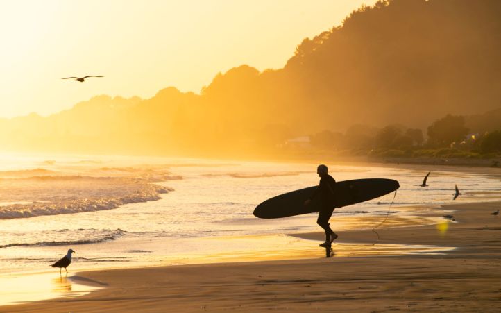 Surfing on Ohope Beach